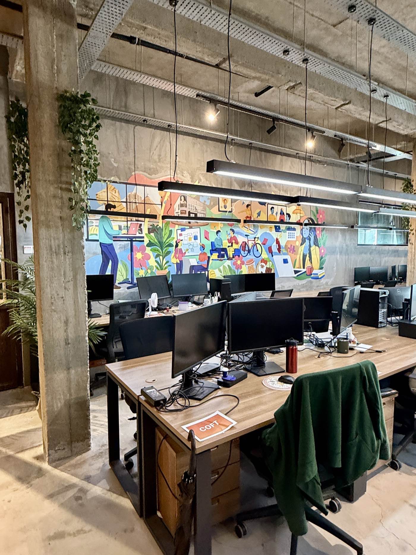 Open dedicated desk floor with mural wall at Sandbox Space Bandar Sunway