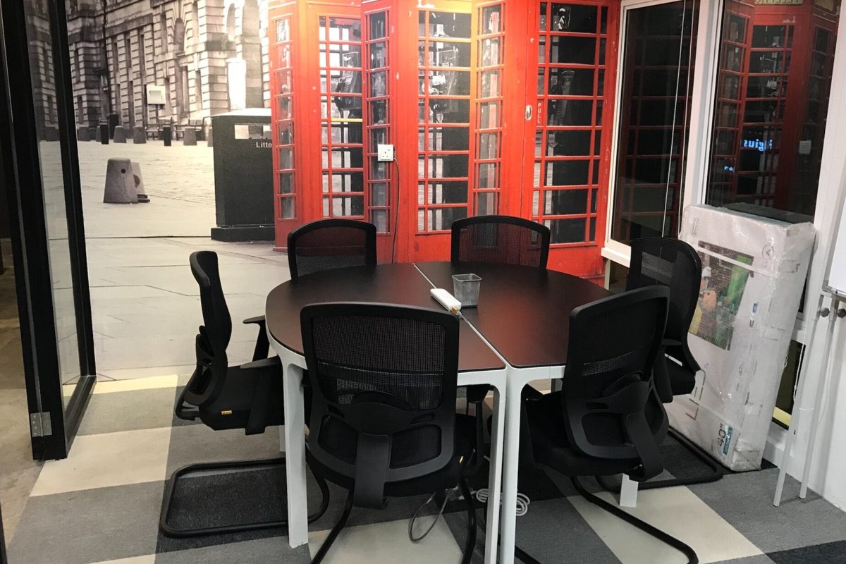 Red phone box mural inside the small meeting room at Sandbox Space Sri Petaling