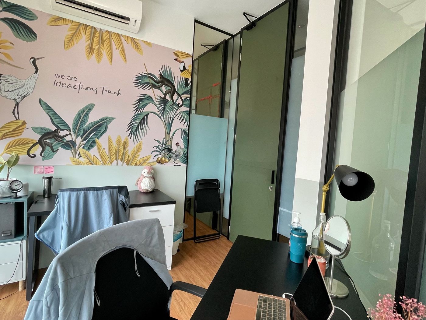 A tenant's private office with their own brand mural at Sandbox Space