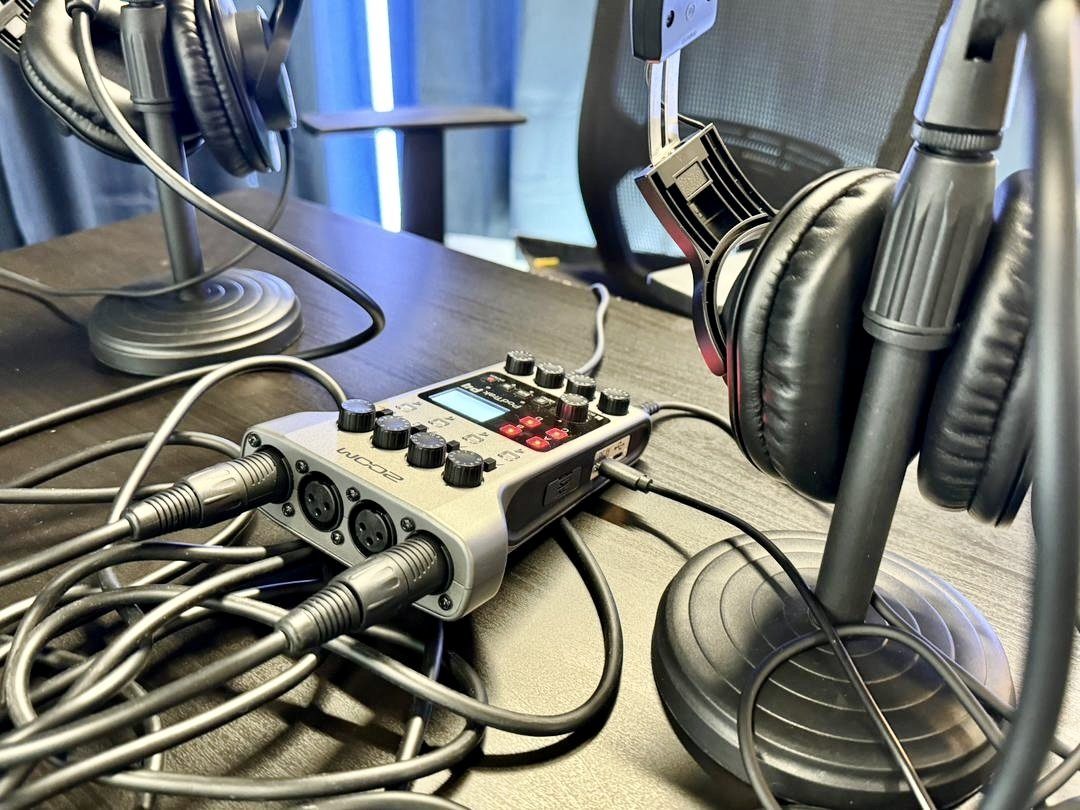 Zoom PodTrak P4 podcast recorder and headphones in the Sandbox studio